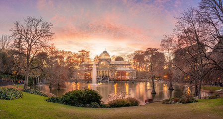 Fototapeta na wymiar The Crystal Palace (Palacio de Cristal) is located in the Retiro park in Madrid, Spain. It is a metal structure used for expositions of contemporaneous art. It is a touristic attraction of the city.