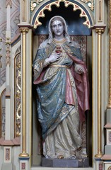 Immaculate heart of Mary statue on the Sacred heart of Jesus altar in the church of Saint Matthew in Stitar, Croatia.
