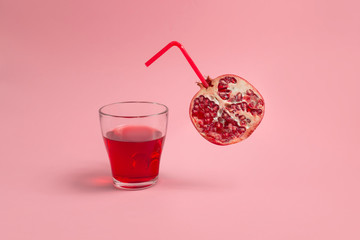 Pomegranate on pastel, pink background. Pomegranate juice concept