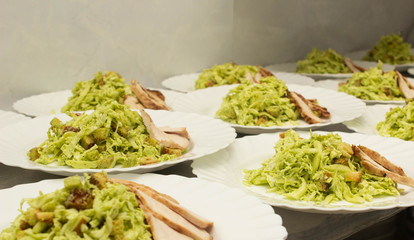 Several servings of cabbage and ham salad, appetizer, banquet preparation, crackers