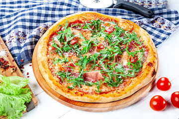 Close up view on pizza on white wooden background with ingridients. Italian cuisine. Ready to Eat. Restaurant, food menu, recipe, cafe concept. Lifestyle with copy space