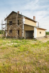 Fototapeta na wymiar Construction of the Unfinished white brick house.