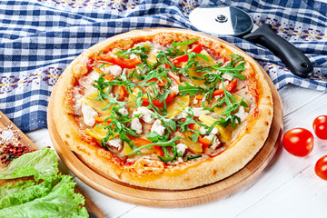 Close up view on pizza on white wooden background with ingridients. Italian cuisine. Ready to Eat. Restaurant, food menu, recipe, cafe concept. Lifestyle with copy space