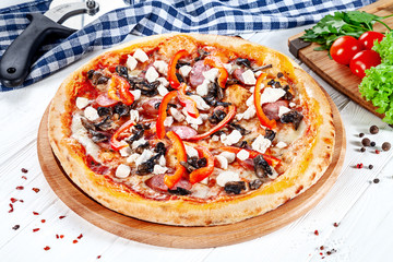 Close up view on pizza on white wooden background with ingridients. Italian cuisine. Ready to Eat. Restaurant, food menu, recipe, cafe concept. Lifestyle with copy space