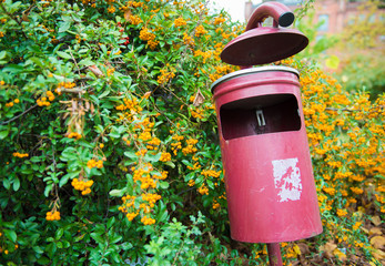 Red garbage Can at park