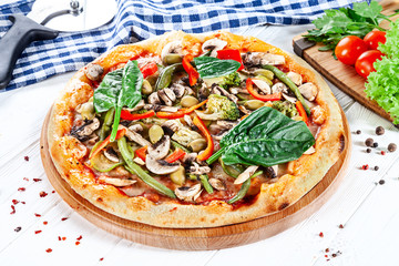 Close up view on pizza on white wooden background with ingridients. Italian cuisine. Ready to Eat. Restaurant, food menu, recipe, cafe concept. Lifestyle with copy space