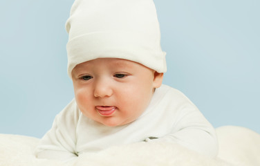 emotional newborn beautiful tender baby lies on a white blanket. The concept of health