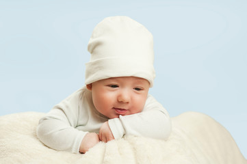 emotional newborn beautiful tender baby lies on a white blanket. The concept of health