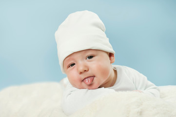 emotional newborn beautiful tender baby lies on a white blanket. The concept of health