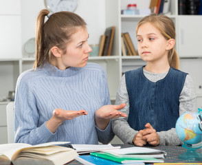 Mom scolds little daughter for poor grades in school