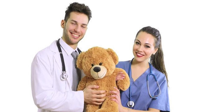 Doctors holding a teddy bear, pediatrician concept