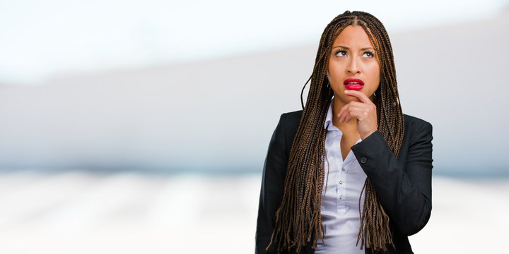 Portrait Of A Young Black Business Woman Doubting And Confused, Thinking Of An Idea Or Worried About Something