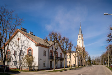 a traditional  street with wooden houses and a church. 