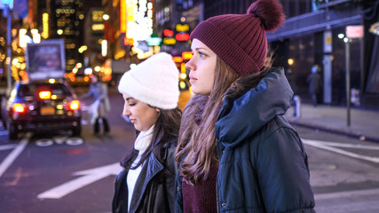 Fototapeta premium Walking on Times Square New York by night while doing a sightseeing trip to Manhattan