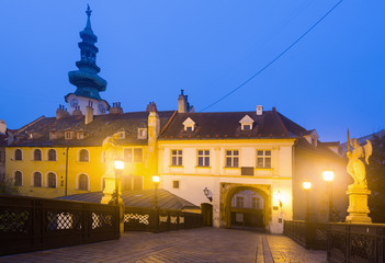 Fototapeta na wymiar Centre of Bratislava with Michael's Gate illuminated at dusk