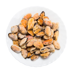 Obraz premium Frozen mussels on a white plate, isolated on white background