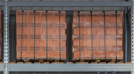 Clay bricks stock pallets stacking at the construction site.