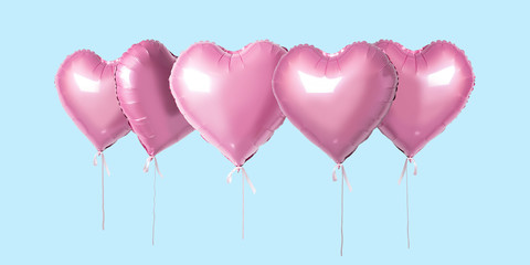 Obraz na płótnie Canvas Bunch of pink color heart shaped foil balloons isolated on bright background. Minimal love concept.