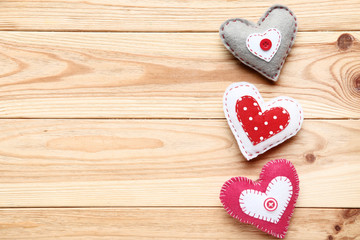 Colorful fabric hearts on brown wooden table