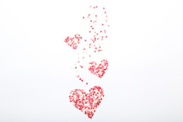 Heart shaped sprinkles on white background