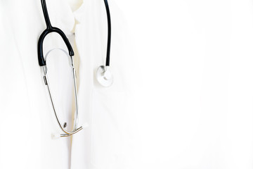 Medical doctor or physician coat with stethoscope around the neck, very bright image on a white background with large copy space