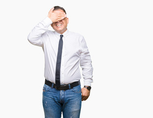 Fototapeta premium Middle age bussines arab man wearing glasses over isolated background smiling and laughing with hand on face covering eyes for surprise. Blind concept.