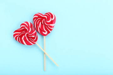 Heart shaped lollipops on blue background