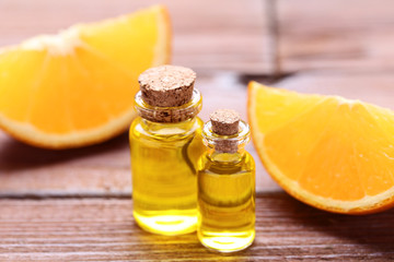 Orange oil in bottles on brown wooden table