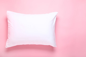 Soft white pillow on pink background