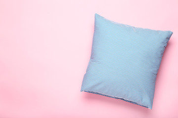 Soft blue pillow on pink background