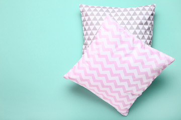 Soft pillows on mint background