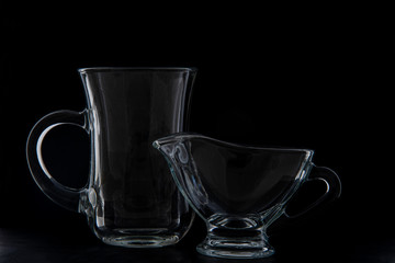 crockery for making coffee, a cup and milk jug. Black background