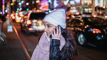 Young woman takes a phone call in the streets of New York