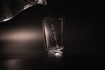 On a black background in a glass of water poured