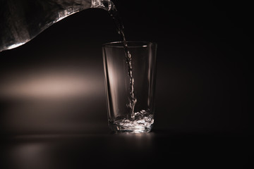 On a black background in a glass of water poured