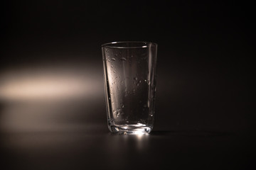 On a black background in a glass of water poured