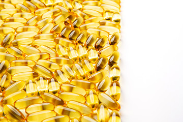 Omega-3 fish fat oil capsules on a white background.