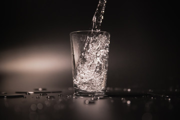 On a black background in a glass of water poured