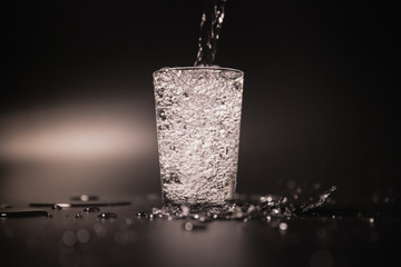 On a black background in a glass of water poured