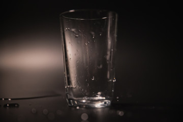 On a black background in a glass of water poured