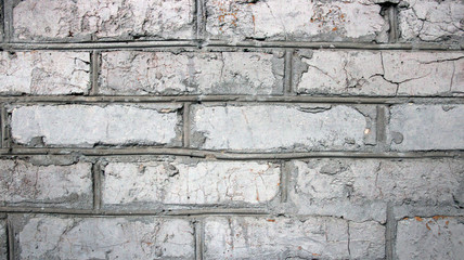 old imitation of a brick wall of concrete with cracks