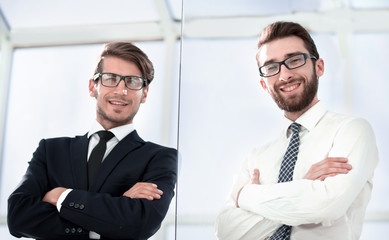 bottom view.two confident businessman standing in the office .