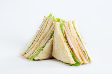 Club sandwich with cheese and party on a white background. White bread is used to make a sandwich....