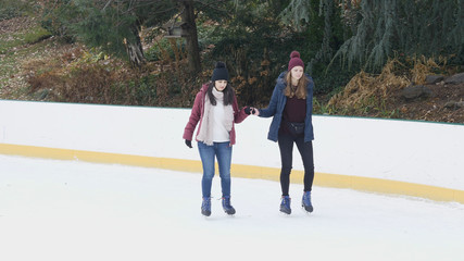 Girls have a lot of fun doing ice skating in New Yorks Central Park