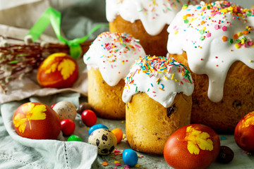 Easter cake and painted eggs on wooden table. Festive composition in rustic style, Springtime. Flat lay, top view background.