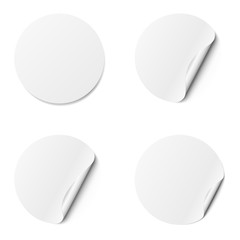 Set of white round adhesive stickers with a folded edges, isolated on white background.