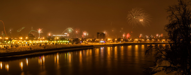 panorama of fireworks in honor of the new year near the river Kuban