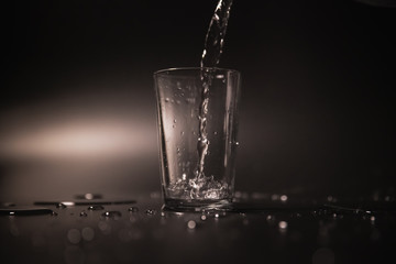 On a black background in a glass of water poured