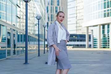 Portrait of a young successful business lady standing among the downtown