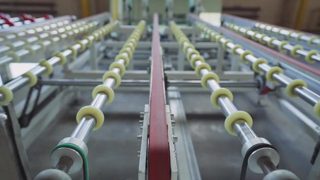 glass for double glazed windows moves on the machine in production. manufacture of glass for double glazed windows